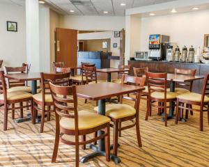 a dining room with wooden tables and chairs at Sleep Inn Elkhart North in Elkhart