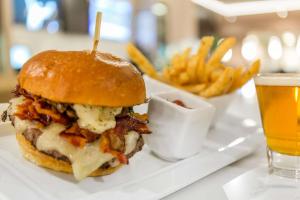 a hamburger and french fries on a white plate at Cambria Hotel Chicago Loop/Theatre District in Chicago