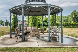a gazebo with a table and chairs under it at Comfort Suites South Bend Near Casino in South Bend