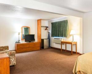 a hotel room with a bed and a television at Quality Inn South in Indianapolis