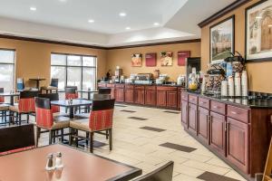 a restaurant with tables and chairs and a cafeteria at Comfort Suites South Bend Near Casino in South Bend