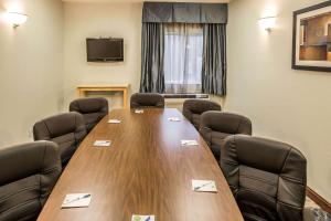 a conference room with a large wooden table and chairs at Comfort Inn Schererville in Schererville