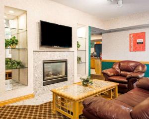 a living room with a couch and a fireplace at Comfort Inn in Goshen