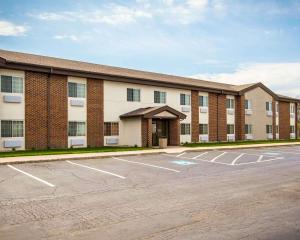 a large brick building with a parking lot at Quality Inn Chesterton near Indiana Dunes National Park I-94 in Chesterton