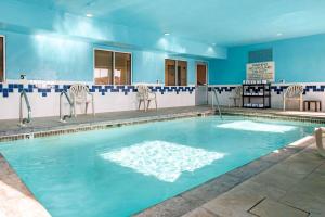 a large swimming pool with chairs at Quality Inn Noblesville-Indianapolis in Noblesville