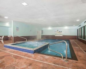 a large indoor swimming pool in a building at Quality Inn Merrillville in Merrillville