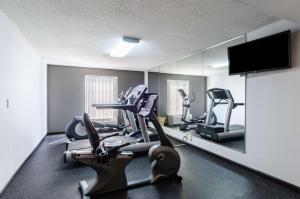 a gym with several tread machines and a mirror at Comfort Inn Randolph-Boston in Randolph