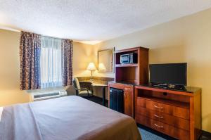 a hotel room with a bed and a desk at Quality Inn Chicopee-Springfield in Chicopee