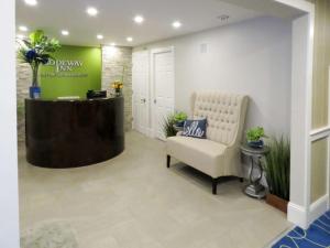 a waiting room with a chair and a reception desk at Rodeway Inn Logan International Airport in Revere