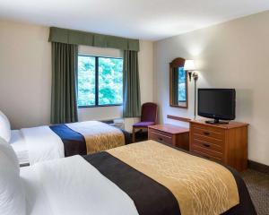 a hotel room with two beds and a flat screen tv at Comfort Inn & Suites - LaVale - Cumberland in La Vale