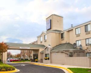 a hotel with a sign on top of it at Sleep Inn Rockville in Rockville