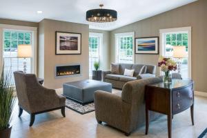 a living room with a couch and a fireplace at Port Inn & Suites Kennebunk, Ascend Hotel Collection in Kennebunk