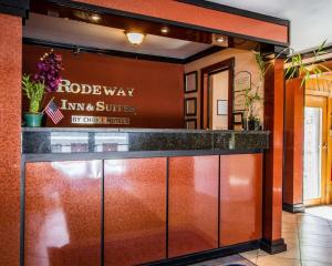 a kitchen with a glass door and a sign on the wall at Rodeway Inn & Suites Brunswick near Hwy 1 in Brunswick