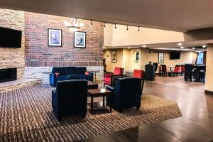 a lobby with couches and chairs and a fireplace at Comfort Inn in Farmington Hills