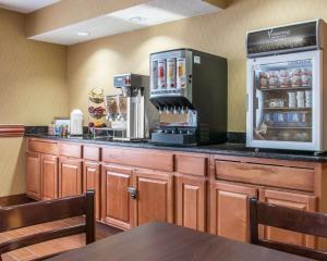 a restaurant with a counter with a coffee maker at Sleep Inn & Suites Grand Rapids Southeast - Kentwood in Grand Rapids