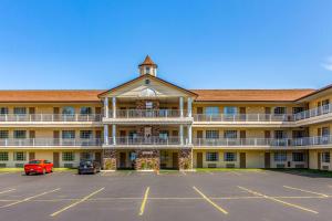 a large building with a parking lot in front of it at Quality Inn Lakefront in Saint Ignace
