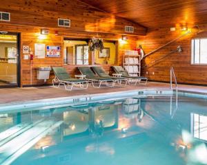 a swimming pool in a room with wooden walls at Quality Inn Ironwood in Ironwood