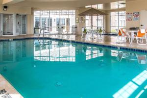 a swimming pool with blue water in a building at Comfort Inn in Chelsea