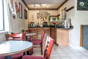 a restaurant with tables and chairs and a kitchen at Econolodge - Paw Paw in Paw Paw