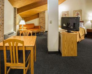 a hotel room with a bed and a flat screen tv at Quality Inn - Dundee in Dundee