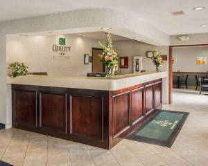 a lobby with a waiting area with flowers on a counter at Quality Inn - Dundee in Dundee