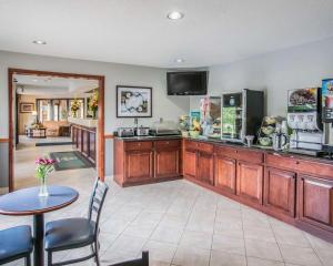 a kitchen with a counter and a table with chairs at Quality Inn - Dundee in Dundee