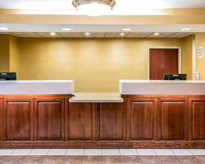 a lobby with a waiting area with wooden cabinets at Quality Inn & Suites Niles in Niles