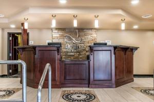 a kitchen with a wooden floor and wooden cabinets at Quality Inn & Suites Houghton in Houghton