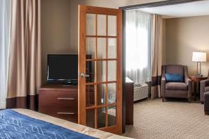a hotel room with a bed and a television at Comfort Inn Fergus Falls in Fergus Falls