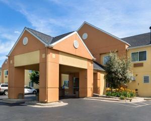 a large building with a parking lot in front of it at Quality Inn Lakeville in Lakeville