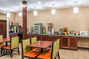 a restaurant with tables and chairs and a counter at Quality Inn & Suites Houghton in Houghton