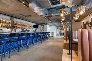 a bar with a row of blue bar stools at Trumbull and Porter - Detroit Downtown in Detroit +58 photos