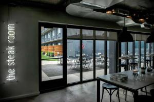 a restaurant with a view of a patio with tables and chairs at Trumbull and Porter - Detroit Downtown in Detroit +41 photos