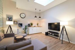 a living room with a couch and a tv at Gertrudy Old Town Apartments in Kraków