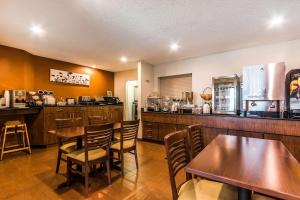 a restaurant with tables and chairs and a kitchen at Sleep Inn Springfield South I60 near Medical District in Springfield