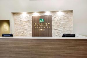 a lobby with a sign for a quality inn and suites at Quality Inn & Suites Arnold in Arnold