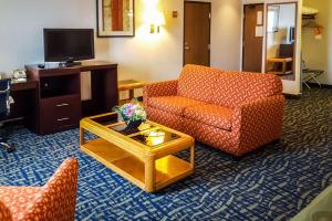 a living room with a couch and a coffee table at Quality Inn in Ozark