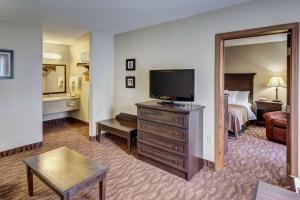 a hotel room with a television and a bed at Quality Inn West in Branson