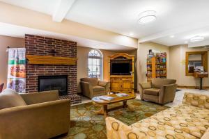 a living room with couches and a fireplace at Quality Inn & Suites Chesterfield Village in Springfield