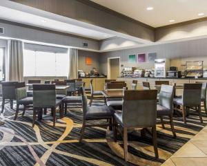 a dining room with tables and chairs and a kitchen at Comfort Inn in Sullivan