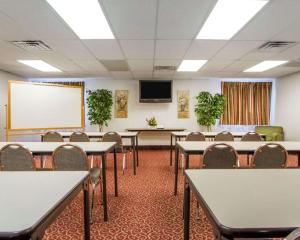 a conference room with tables and chairs and a whiteboard at Comfort Inn Bolivar in Bolivar