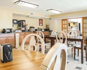 a dining room with a table and chairs and a kitchen at Econo Lodge Kansas City Downtown North in Kansas City