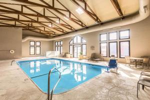 a large swimming pool in a large room with windows at Quality Inn in West Plains