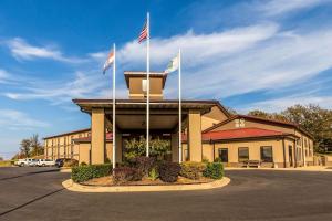 Um edifício com três bandeiras americanas à frente. em Quality Inn em West Plains