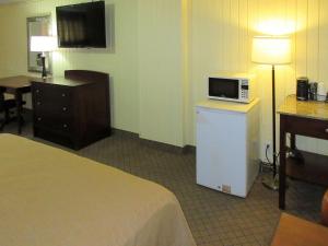 A bed or beds in a room at Rodeway Inn