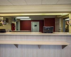 an office reception counter with a large mirror at Relax Inn Saint Charles in St. Charles