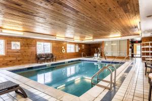 a large indoor pool with a wooden ceiling at Comfort Inn & Suites - Hannibal in Hannibal