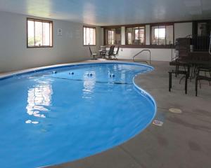 a large blue swimming pool in a building at Quality Inn Farmington in Farmington