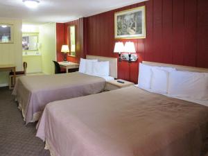 A bed or beds in a room at Rodeway Inn