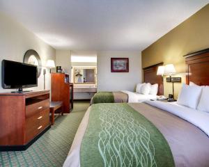 a hotel room with two beds and a flat screen tv at Quality Inn Brookhaven in Brookhaven